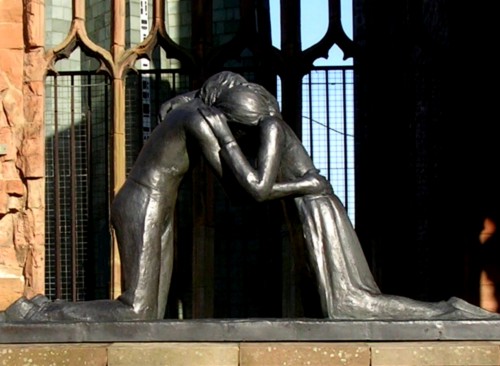 The Transformative Power Of Acceptance. Photo of a bronze statue at Coventry Cathedral depicting a man and a woman embracing in forgiveness.