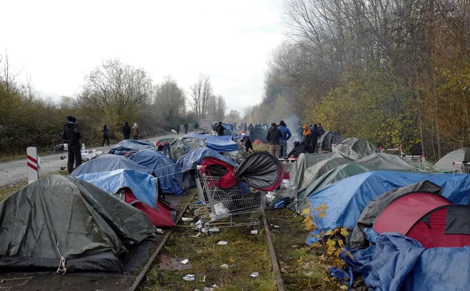Give Thanks In Everything. Respond To What Happens Don’t React. Photo of a refugee camp in Calais, France.