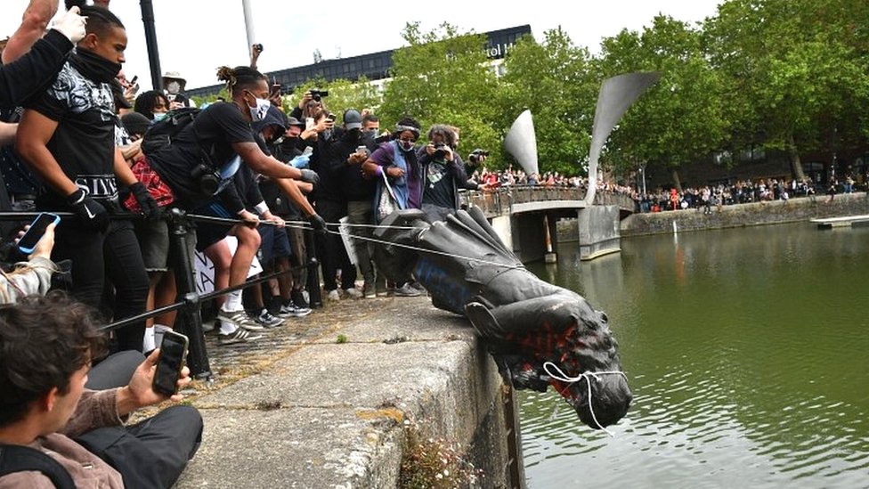 Historical revisionism. Photo of statue of Bristol slave trader Edward Colston being thrown into the harbour by Black Lives Matters protesters.