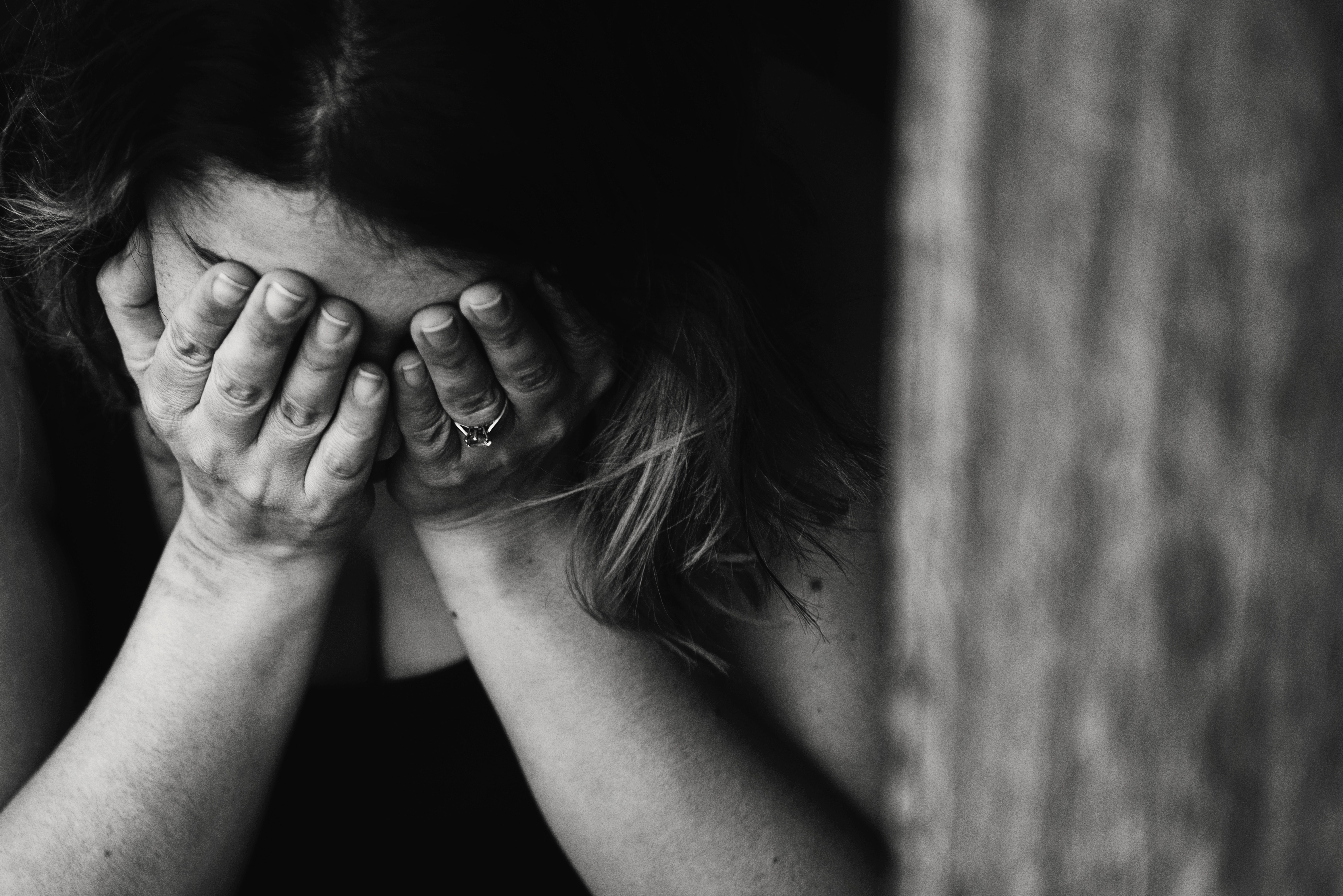 How much time does it take before you can  be able to move on? Picture of a distressed woman with her head in her hands.