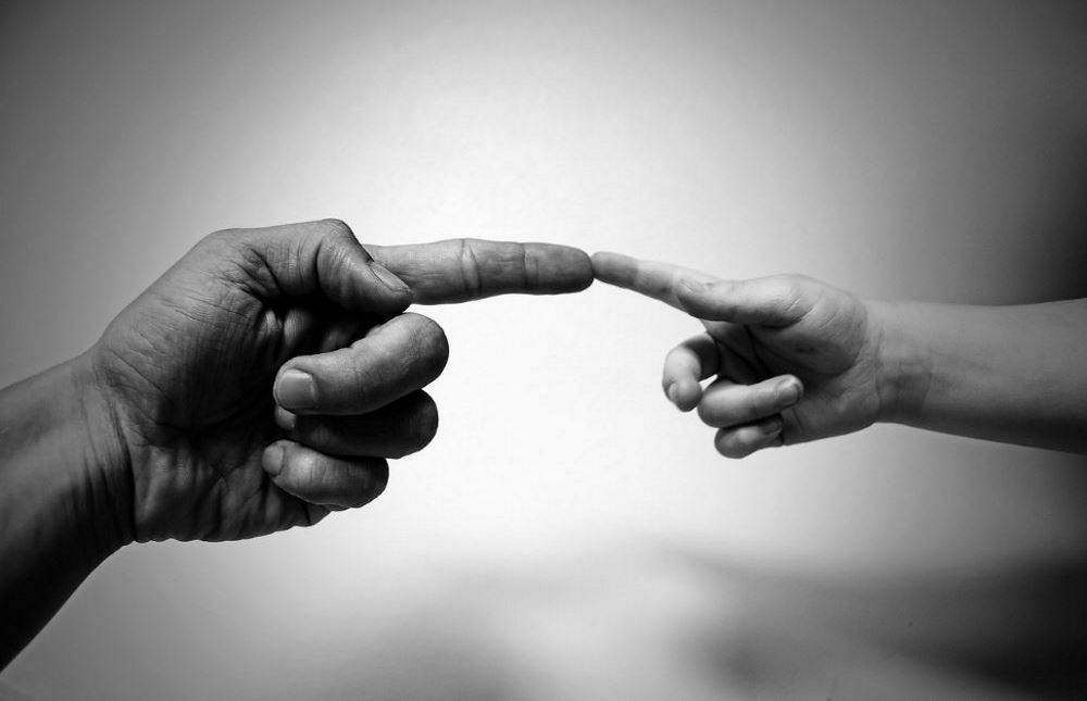 Generativity. What Difference Did You Make? What Impact Will You Leave In The Lives Of Others? Picture of an old finger and a young finger touching at the finger tips.