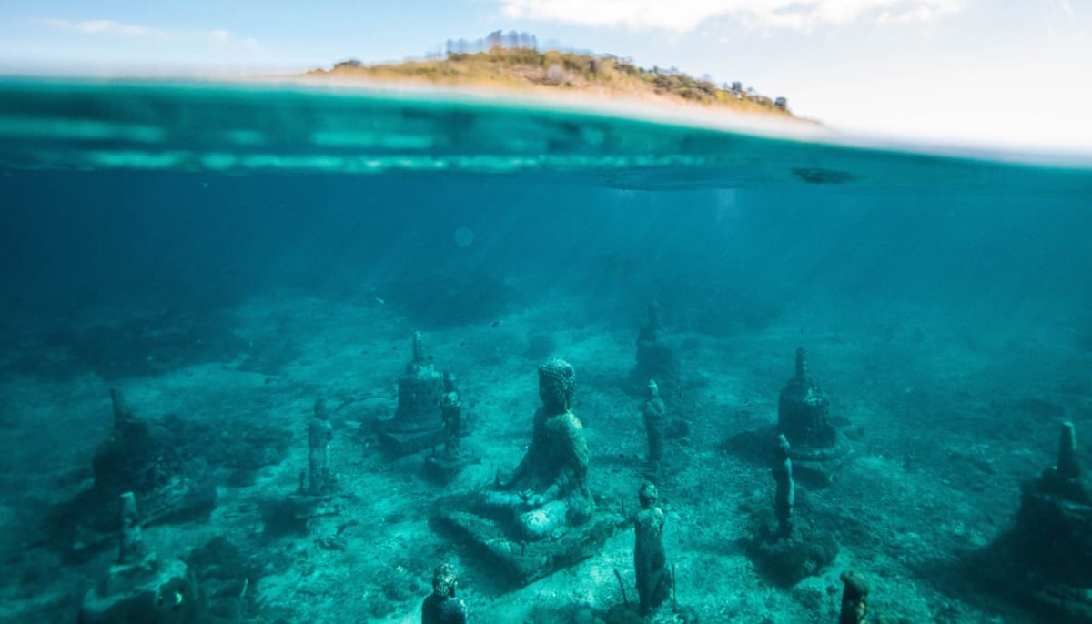 How To Wake Up - Rest. Pic of buddha statues under water.