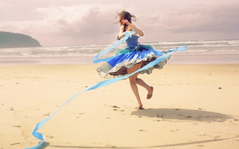 Going With The Flow -The Balance Of Being And Doing. Steer the boat each day rather than plan ahead way into the future. Image of a girl in a flowing blue dress on a sandy beach dancing.