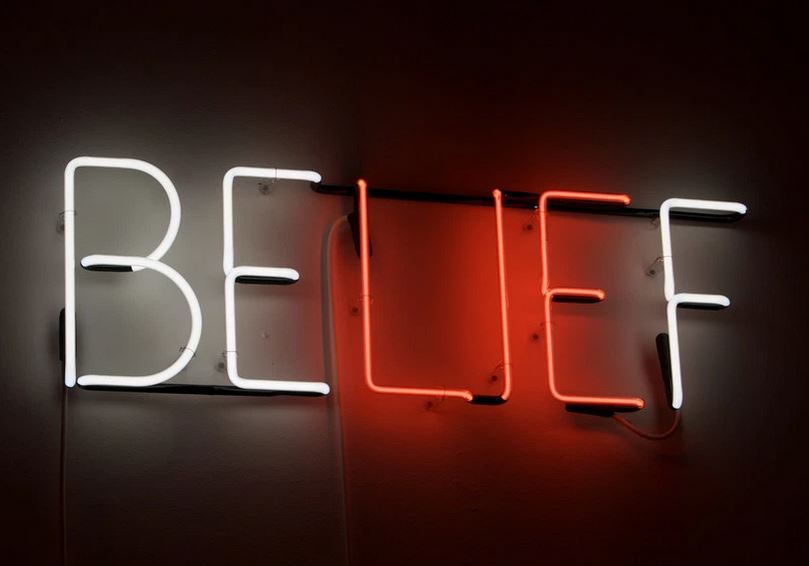 Belief - A Terrible Tyrant Or An Empowering Servant. To Believe Or Not To Believe - That Is The Question. Image of a neon sign.