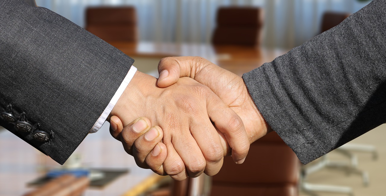 The Art Of Persuasion - Identifying And Satisfying The Other Person's Need. Picture of shaking hands.