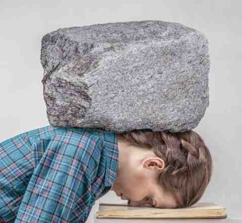 Can You Stop Thinking? Discover The Joy Of A Quiet Mind. Cherish the times when you are not thinking about anything. Picture of a woman with her head on a table.