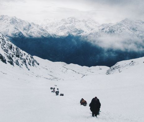 Walking The Talk. Don't explain your philosophy. Embody it! Photograph of an expedition leader leads his team up a snowy mountain.