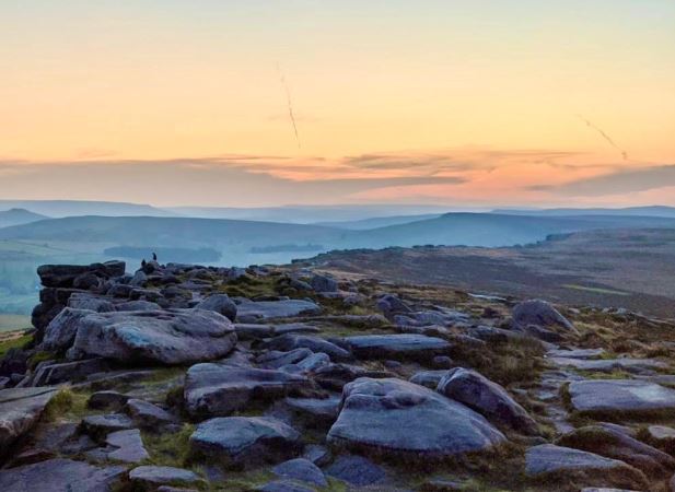 Zen Thoughts - Conversations with a friend. 2 people chatting on a ridge of rocks as the sun sets.